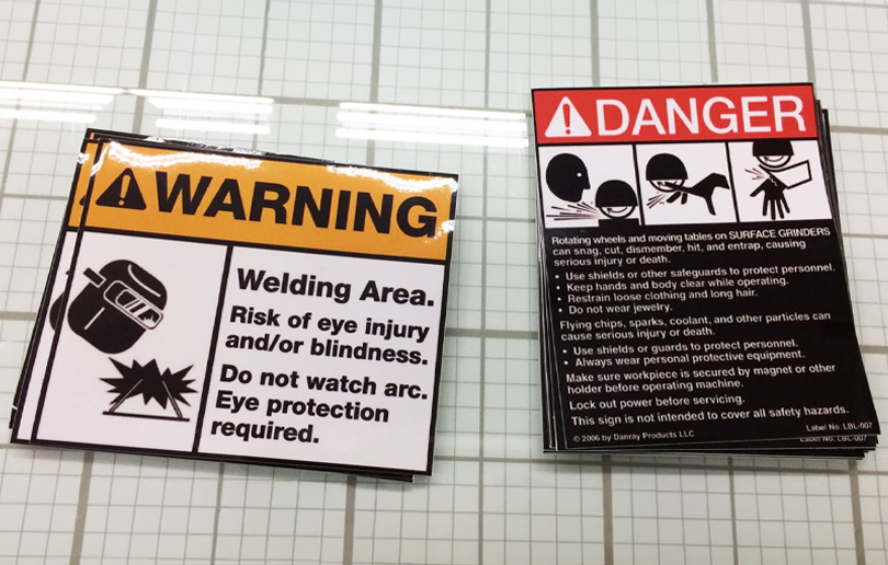 High-performance industrial vinyl sticker printing for safety signage, featuring UV-stable protective lamination and high-visibility colours.