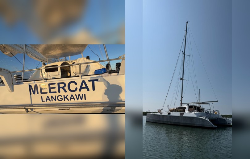 Catamaran boat named “Meercat Langkawi” showing close-up hull branding and full vessel view on calm water under clear sky. Boat Decals by Signarama CBD