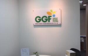 Corporate reception sign with full-colour logo printing mounted on clear acrylic panel.