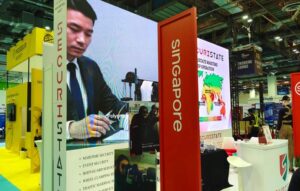Securistate exhibition booth featuring illuminated graphics, branded pillars, and large-format display panels at a trade exhibition.