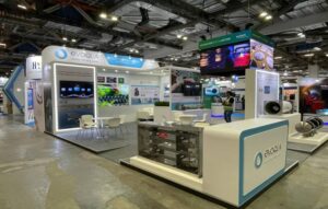 Evoqua exhibition booth featuring illuminated graphics, product displays, custom structures, and branded exhibition counters.