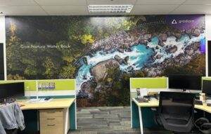 Large format wall mural Singapore office showing aerial river landscape branding